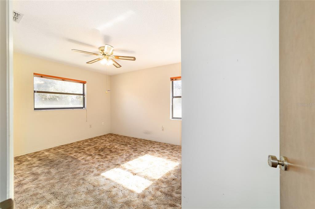 10700 Southeast Sunset Harbor Road Summerfield, FL 34491 - Photo 33 of 41 a view of empty room with a ceiling fan