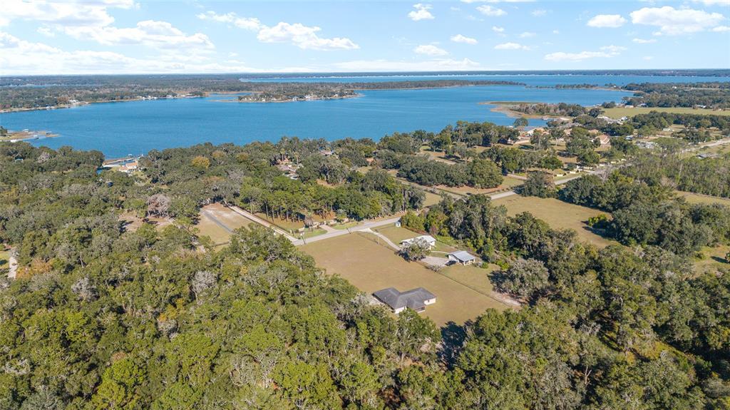 10700 Southeast Sunset Harbor Road Summerfield, FL 34491 - Photo 4 of 41 an aerial view of a house with a lake view