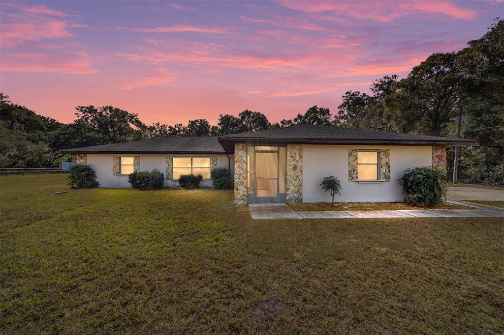 10700 Southeast Sunset Harbor Road Summerfield, FL 34491 - Photo 8 of 41 a view of a house with a yard