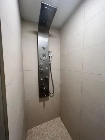 a bathroom with a shower and mirror