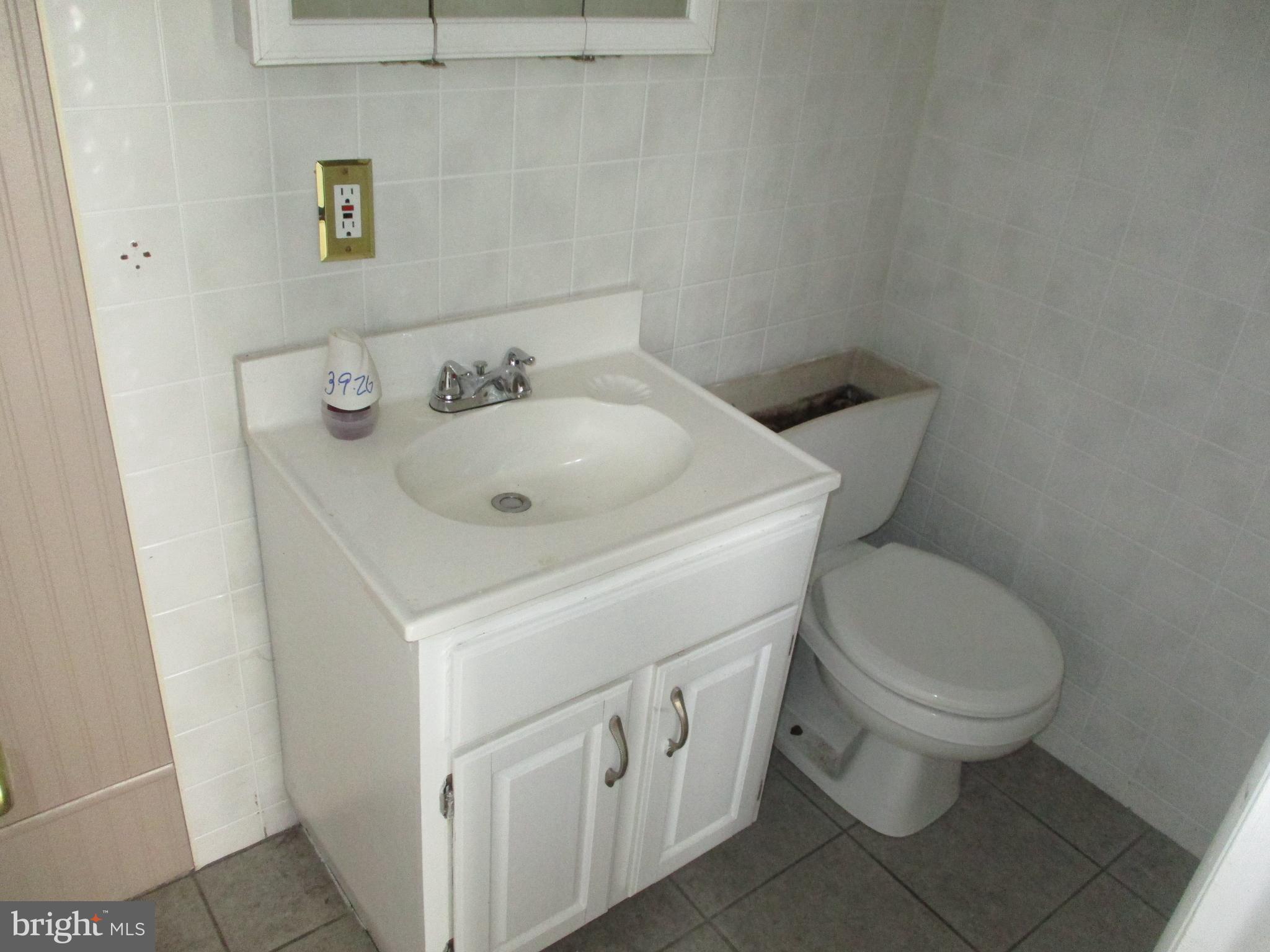 31 Village Road Shenandoah, PA 17976 - Photo 10 of 20 a white toilet sitting next to a bathroom sink