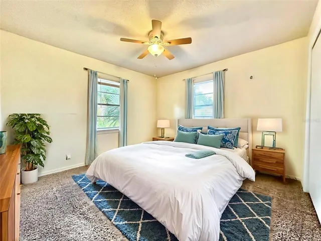 a bedroom with bed and a potted plant