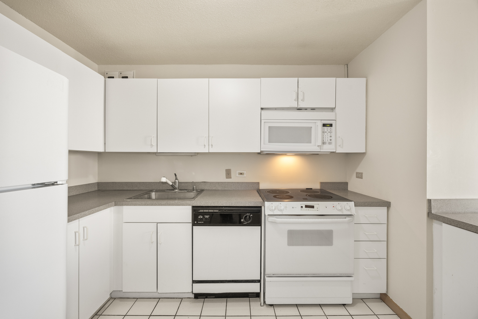 405 North Wabash Avenue, Unit 2801 Chicago, IL 60611 - Photo 22 of 29 a kitchen with white cabinets and white appliances