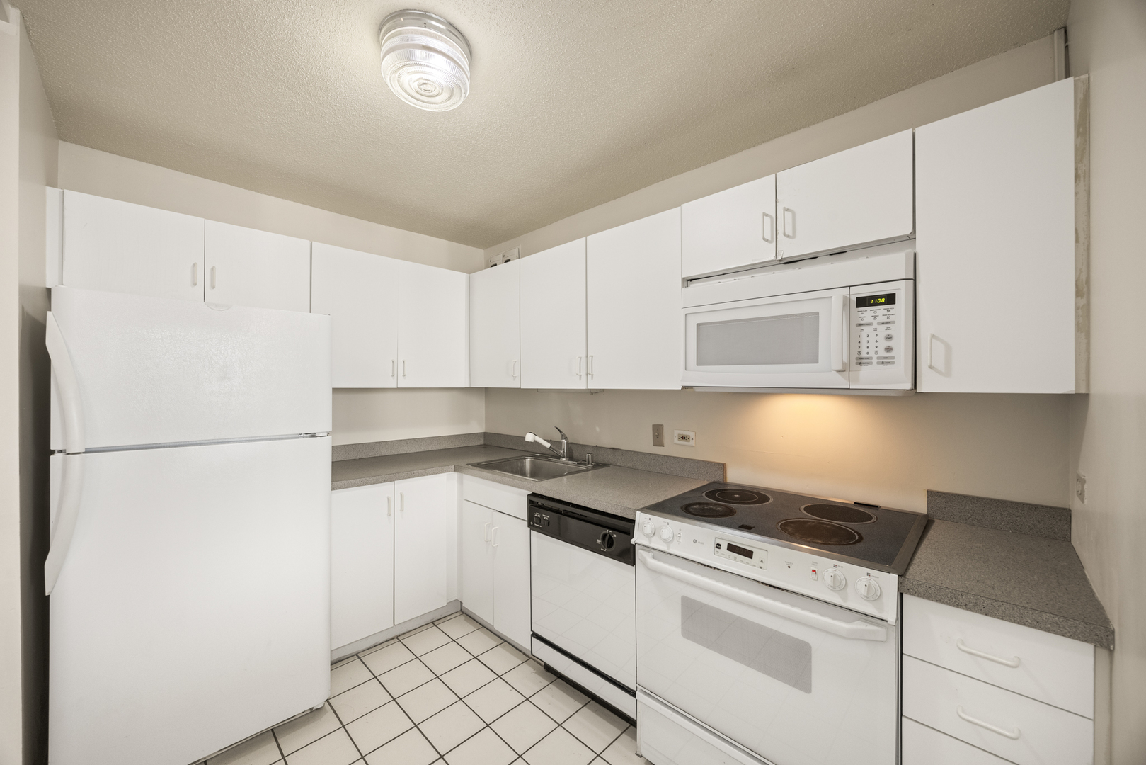 405 North Wabash Avenue, Unit 2801 Chicago, IL 60611 - Photo 24 of 29 a kitchen with white cabinets and white appliances