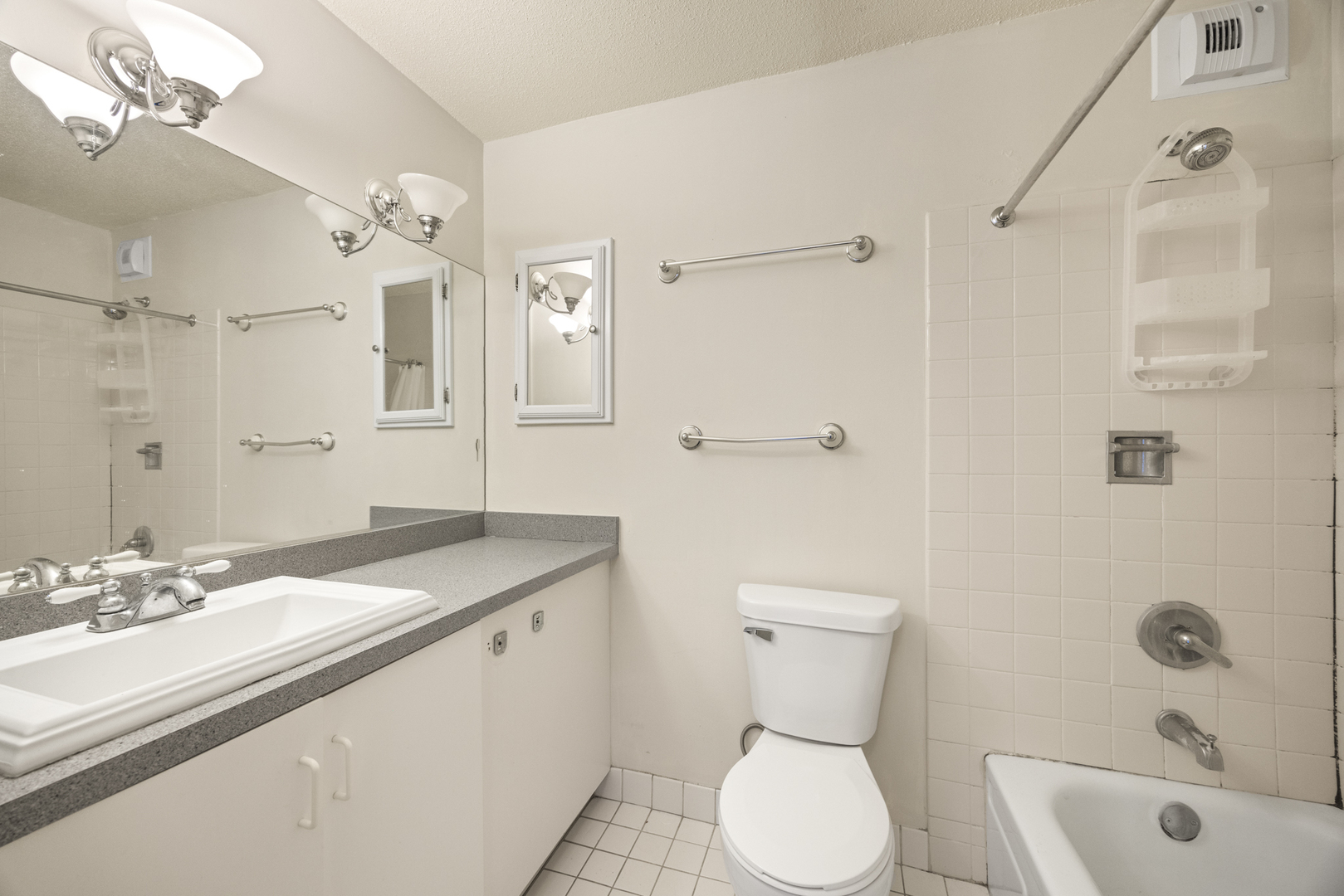405 North Wabash Avenue, Unit 2801 Chicago, IL 60611 - Photo 28 of 29 a bathroom with a granite countertop toilet sink and mirror
