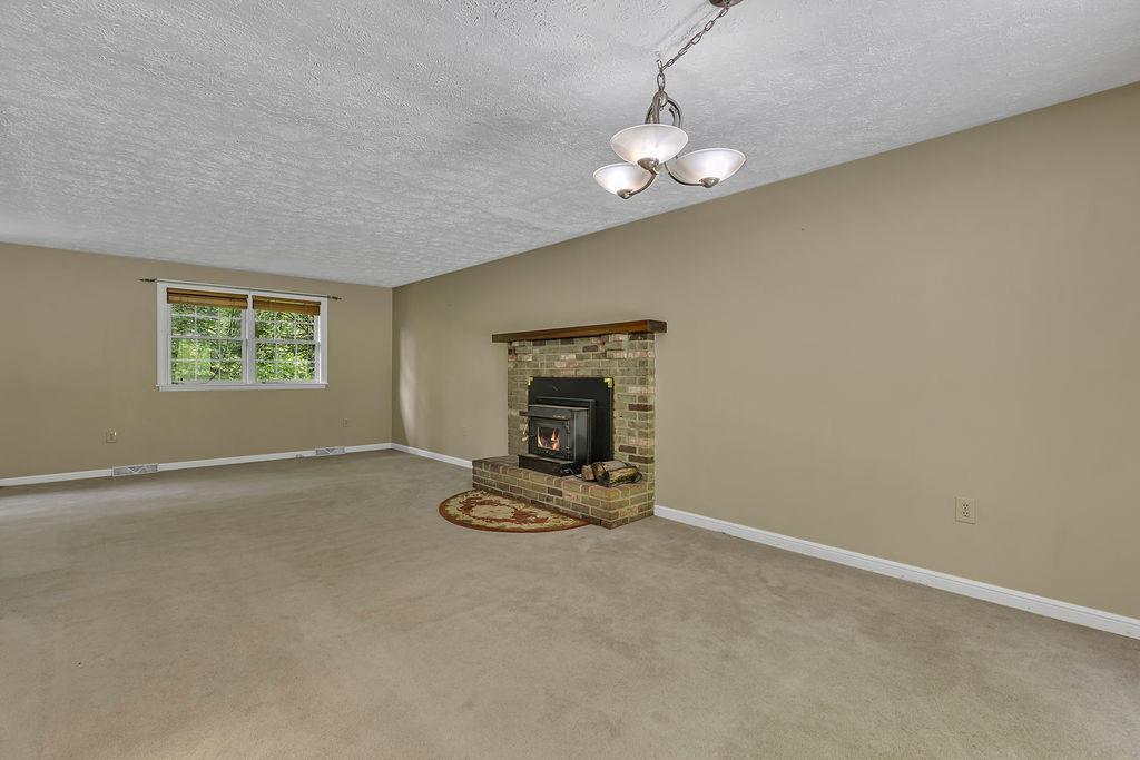 171 Dehaven Road Beaver Falls, PA 15010 - Photo 12 of 35 an empty room with windows and fireplace