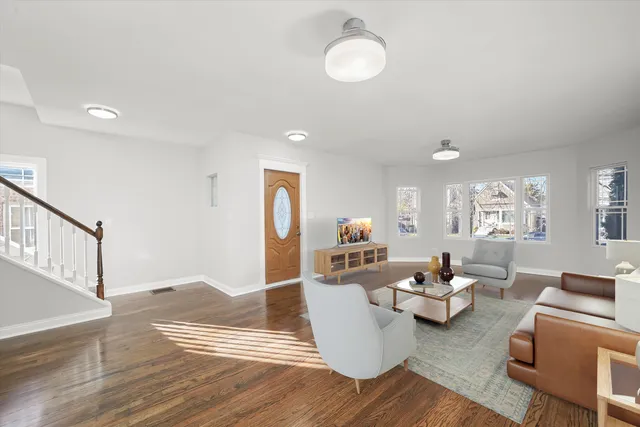 a living room with furniture flat screen tv and window