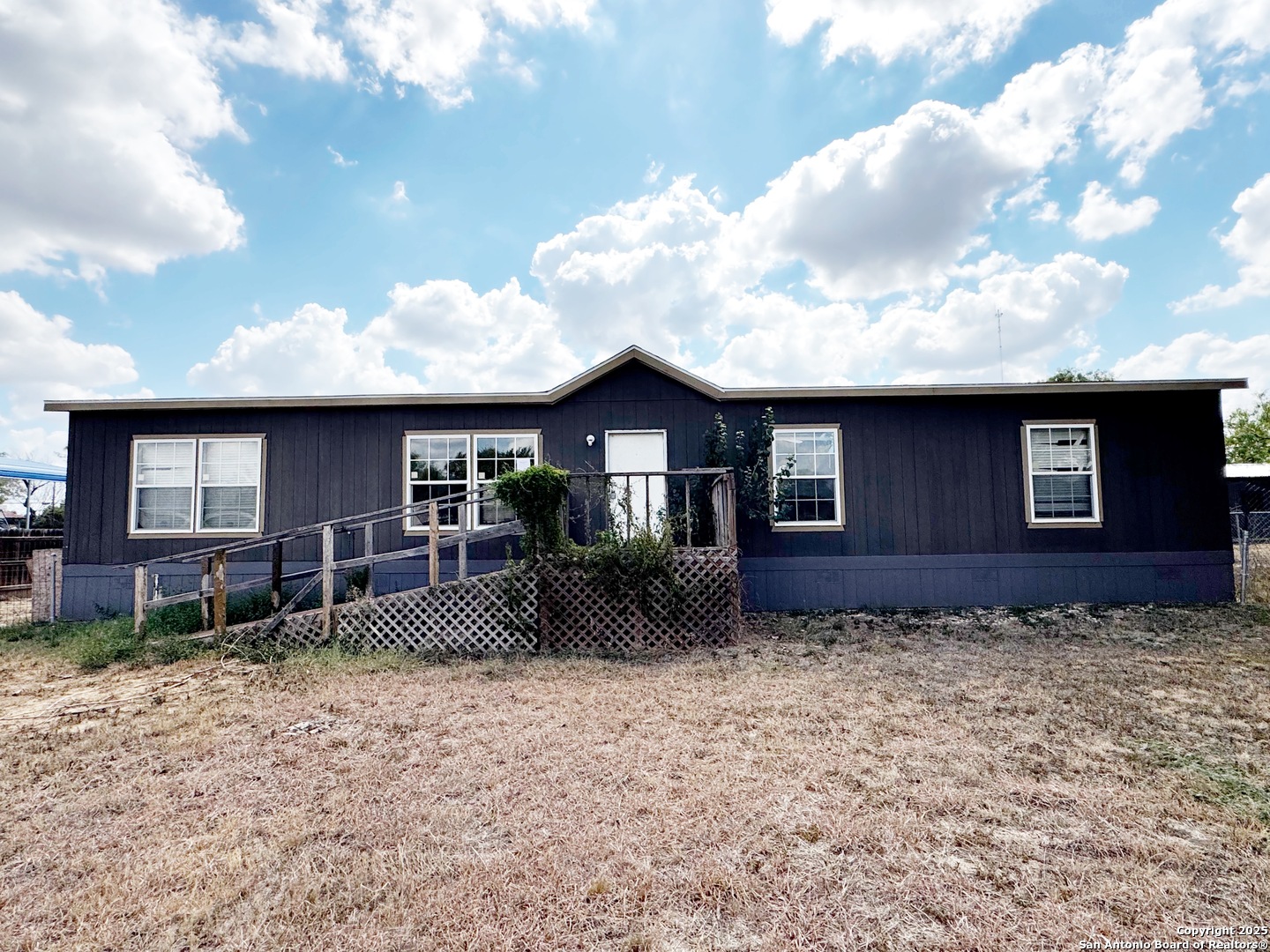 808 Pecan Street Jourdanton, TX 78026 - Photo 15 of 17 a front view of a house with garden