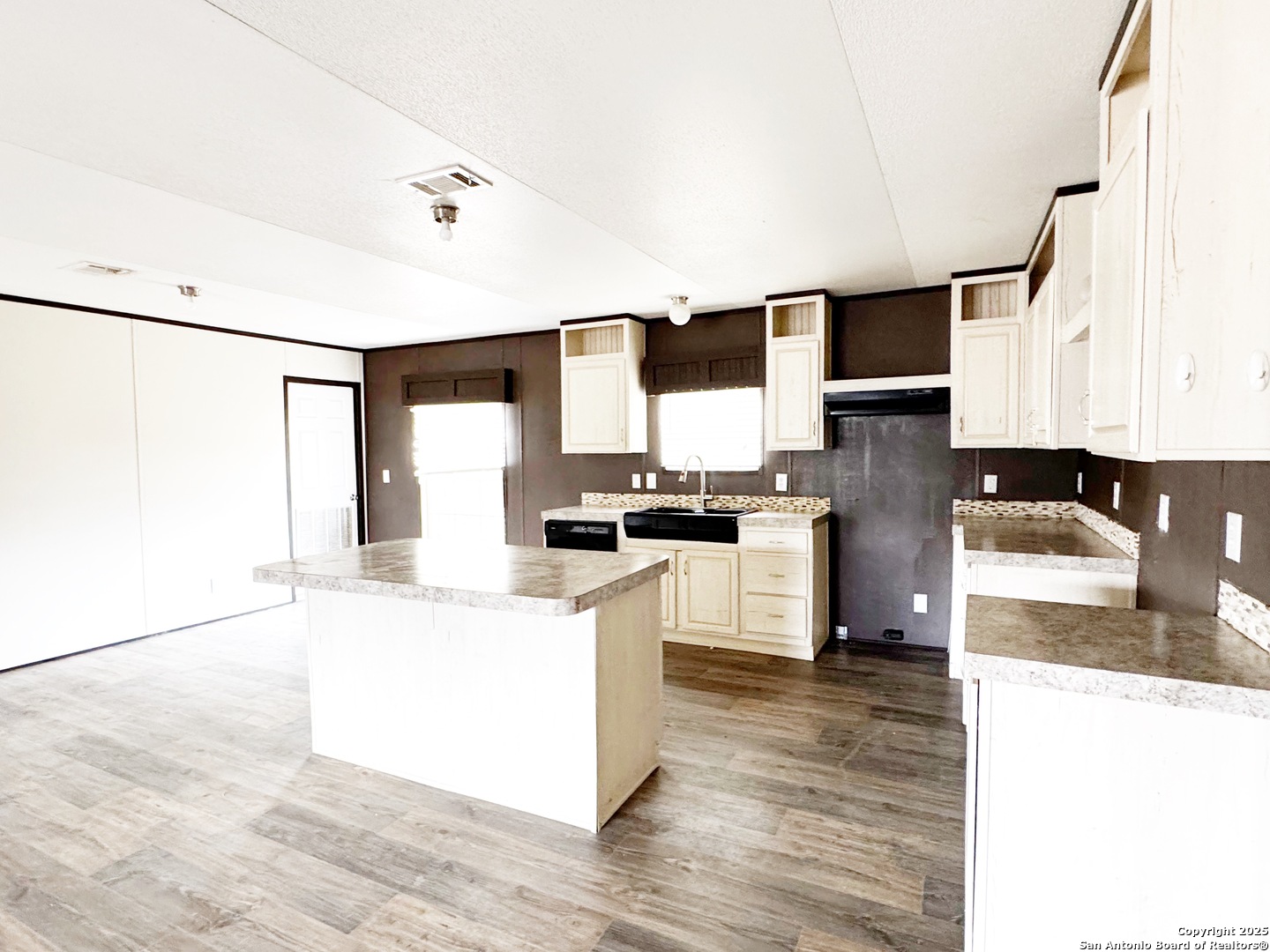 808 Pecan Street Jourdanton, TX 78026 - Photo 4 of 17 a kitchen with a refrigerator and a stove top oven