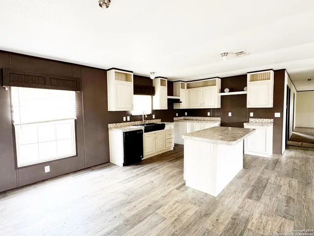 a kitchen with granite countertop a stove top oven and sink