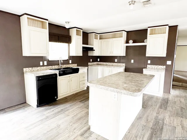 a kitchen with a sink and a stove top oven