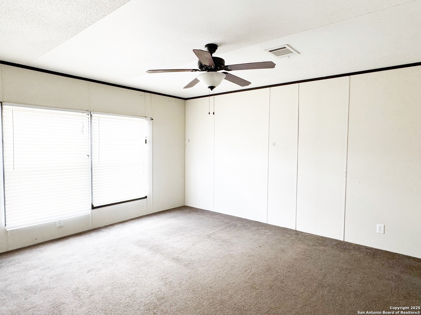 808 Pecan Street Jourdanton, TX 78026 - Photo 7 of 17 a view of an empty room with a window