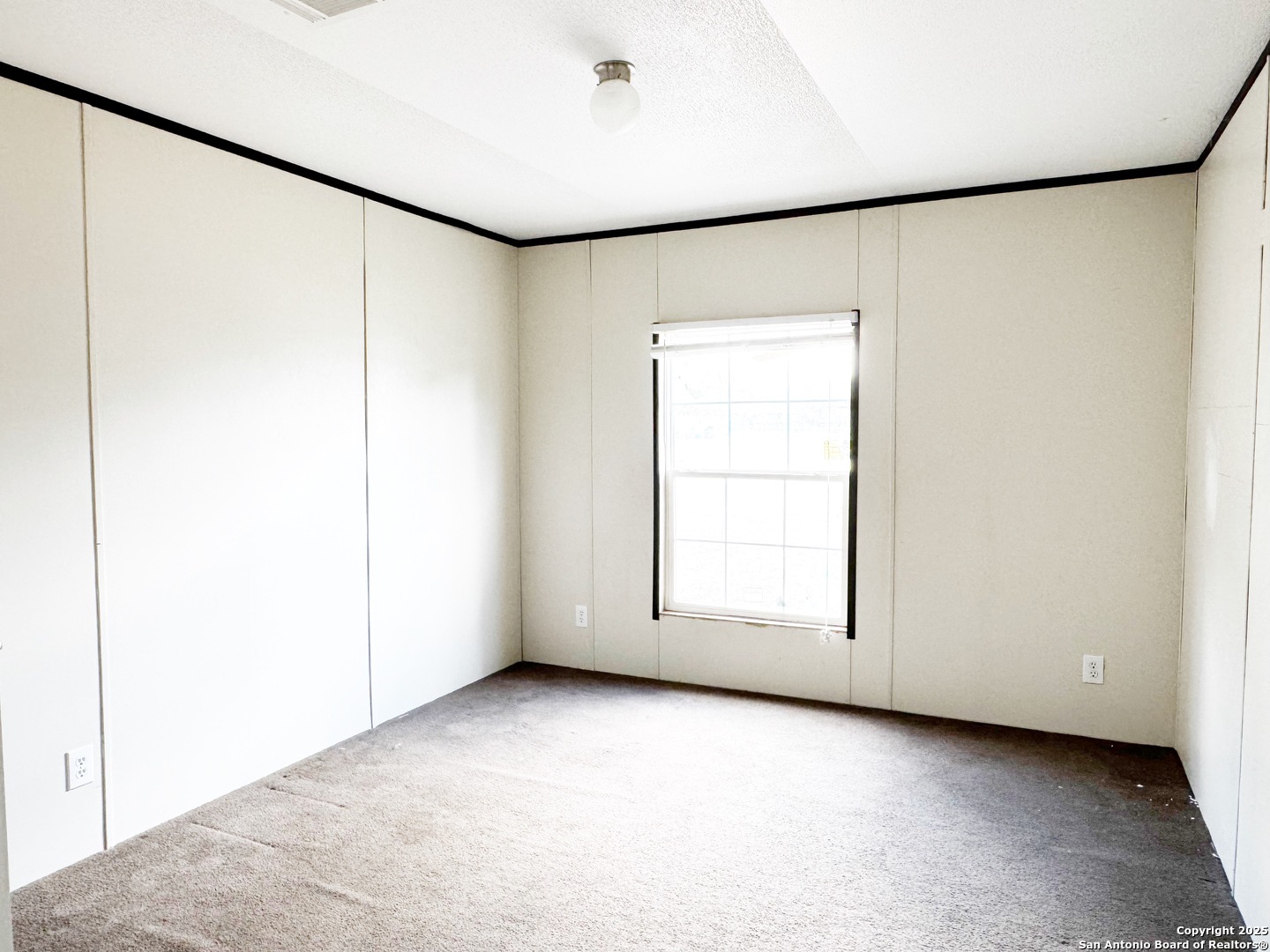 808 Pecan Street Jourdanton, TX 78026 - Photo 9 of 17 a view of a room with window