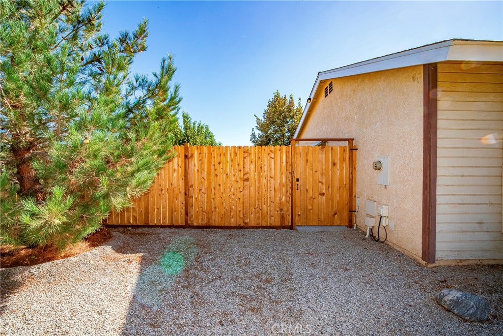 9642 East Ave R 14 Littlerock, CA 93543 - Photo 13 of 66 a view of backyard with plants and wooden fence
