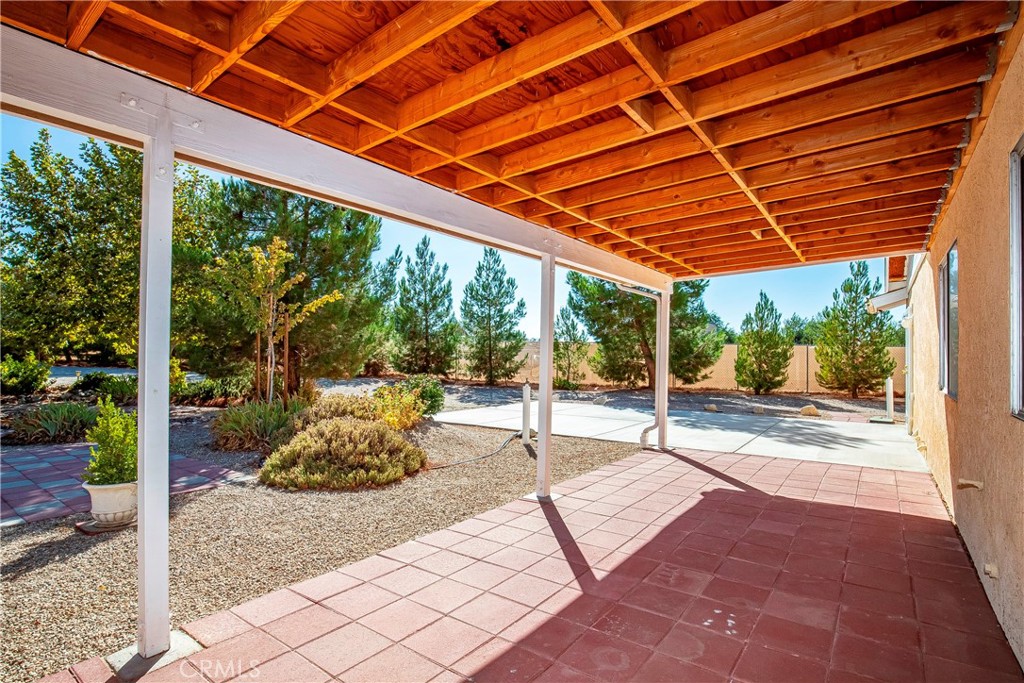 9642 East Ave R 14 Littlerock, CA 93543 - Photo 19 of 66 a patio with yard glass top table and chairs