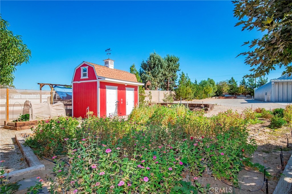 9642 East Ave R 14 Littlerock, CA 93543 - Photo 31 of 66 a sign that is in front of flowers