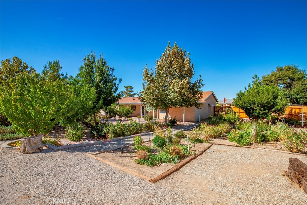 9642 East Ave R 14 Littlerock, CA 93543 - Photo 36 of 66 a front view of a house with a yard and garage