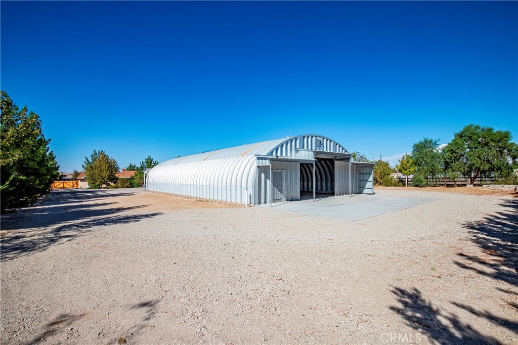 9642 East Ave R 14 Littlerock, CA 93543 - Photo 42 of 66 a front view of a house with a yard