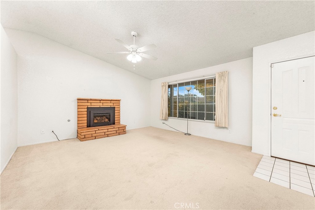 9642 East Ave R 14 Littlerock, CA 93543 - Photo 53 of 66 an empty room with floor to ceiling window and fireplace