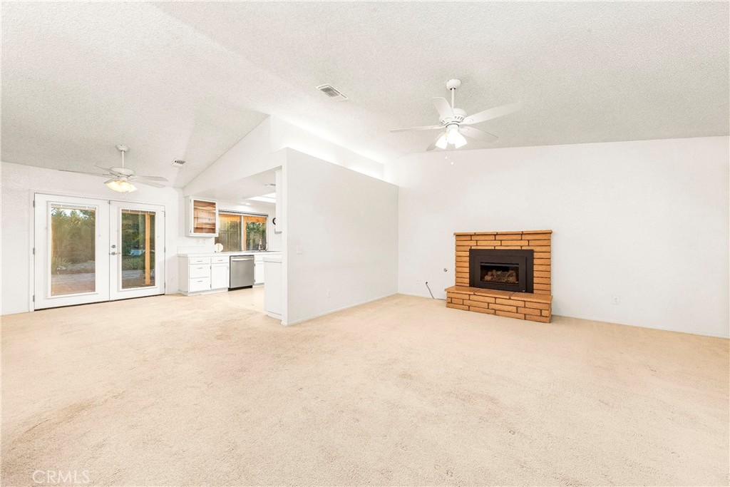9642 East Ave R 14 Littlerock, CA 93543 - Photo 54 of 66 an empty room with fireplace and windows