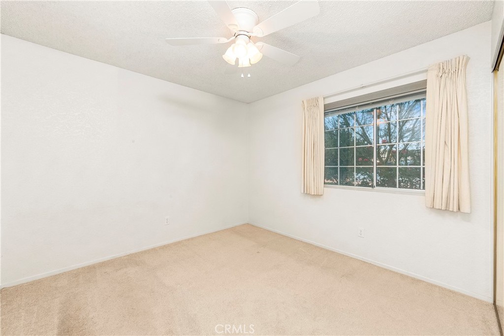 9642 East Ave R 14 Littlerock, CA 93543 - Photo 58 of 66 an empty room with a window and a fan