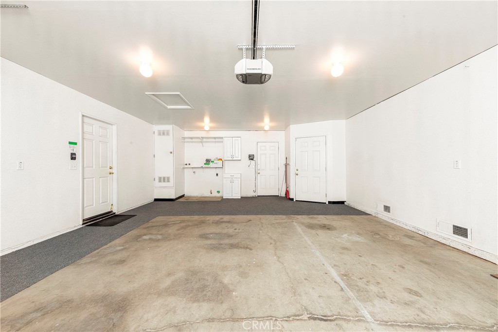 9642 East Ave R 14 Littlerock, CA 93543 - Photo 66 of 66 a view of a room with cabinet and a chandelier fan