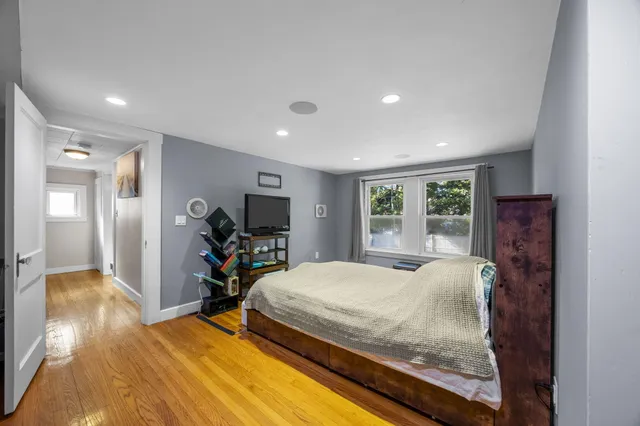 a bed room with a bed and a television