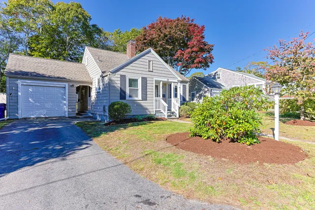a front view of a house with a yard and a garage