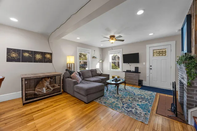 a living room with furniture and a fireplace