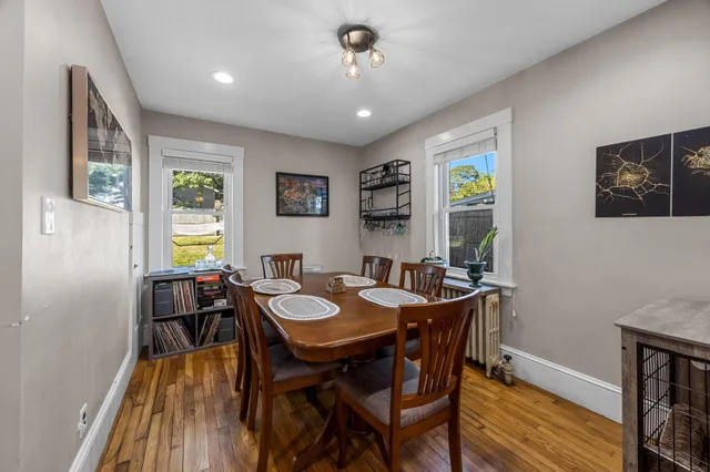 a view of a dining room with furniture window and wooden floor