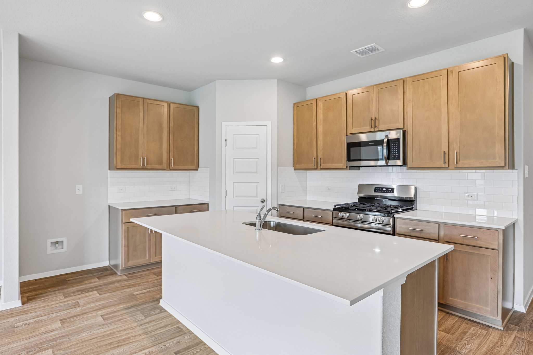 5513 Sacra Cove Austin, TX 78747 - Photo 7 of 37 a kitchen with stainless steel appliances granite countertop a sink stove and microwave
