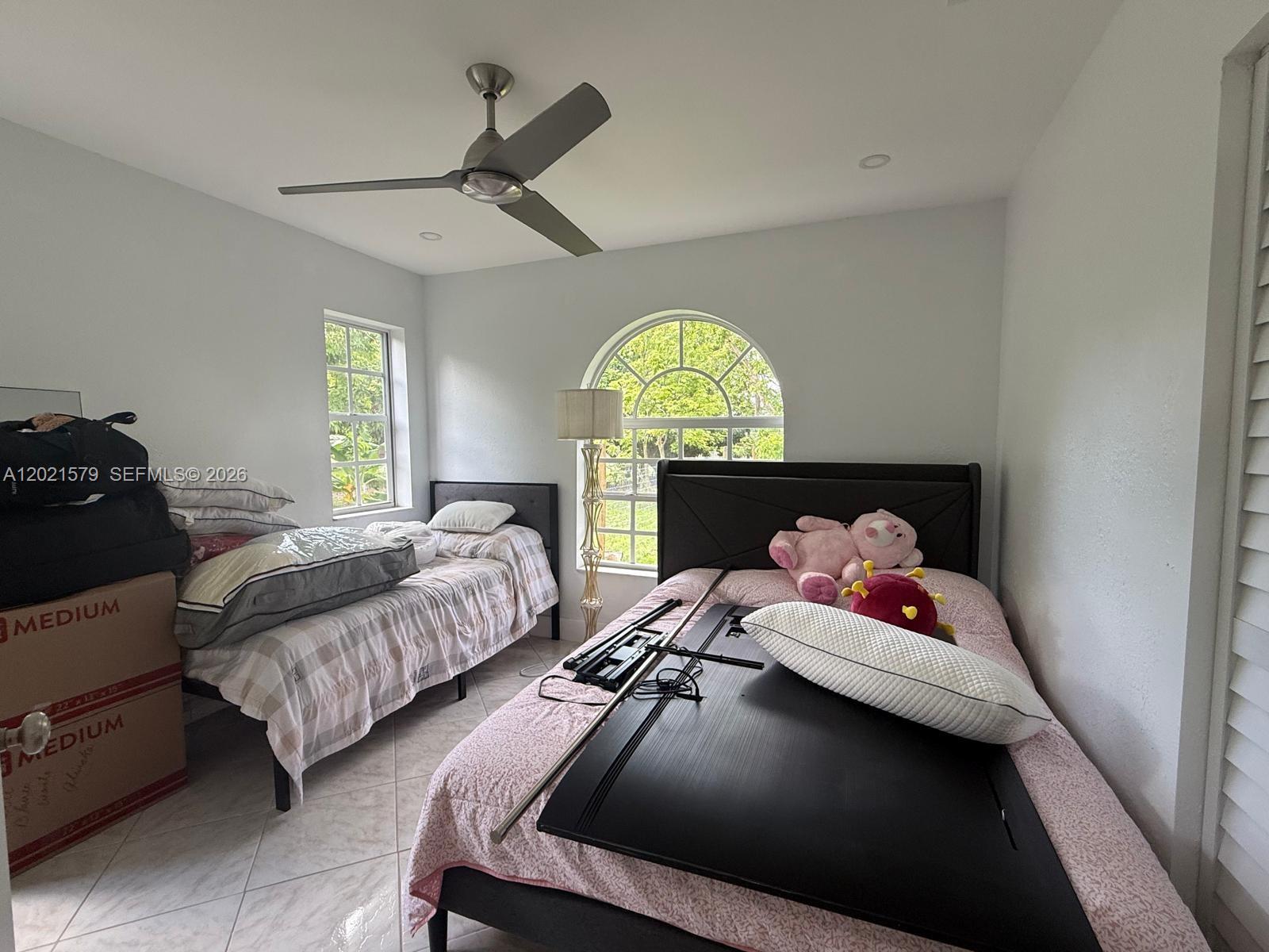 22445 Southwest 264th Street Homestead, FL 33031 - Photo 9 of 12 a bedroom with a bed and a window