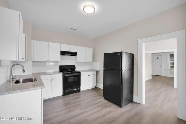 a kitchen with a refrigerator stove and sink