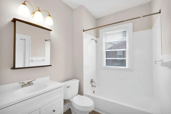 a bathroom with a toilet a sink and a bath tub