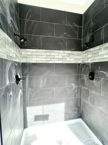 an empty room with windows and cabinet