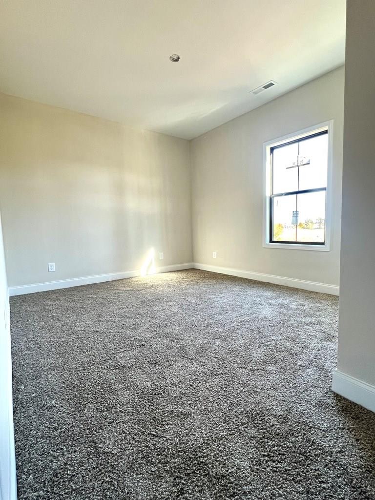 416 Old Major Road Hopkinsville, KY 42240 - Photo 22 of 29 an empty room with chandelier fan and windows