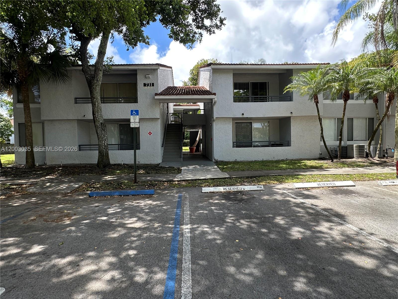 731 Lyons Road, Unit 16203 Coconut Creek, FL 33063 - Photo 1 of 14 a view of a house with a yard
