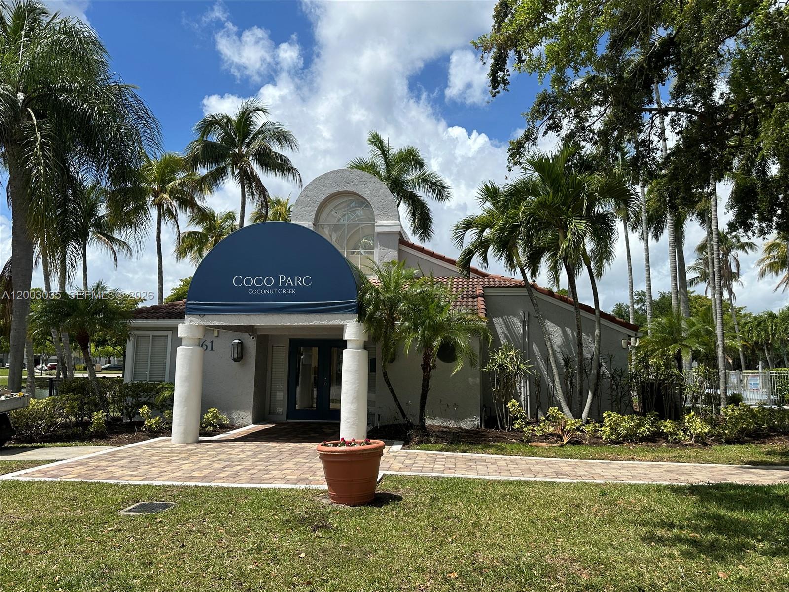 731 Lyons Road, Unit 16203 Coconut Creek, FL 33063 - Photo 12 of 14 a front view of a house with garden