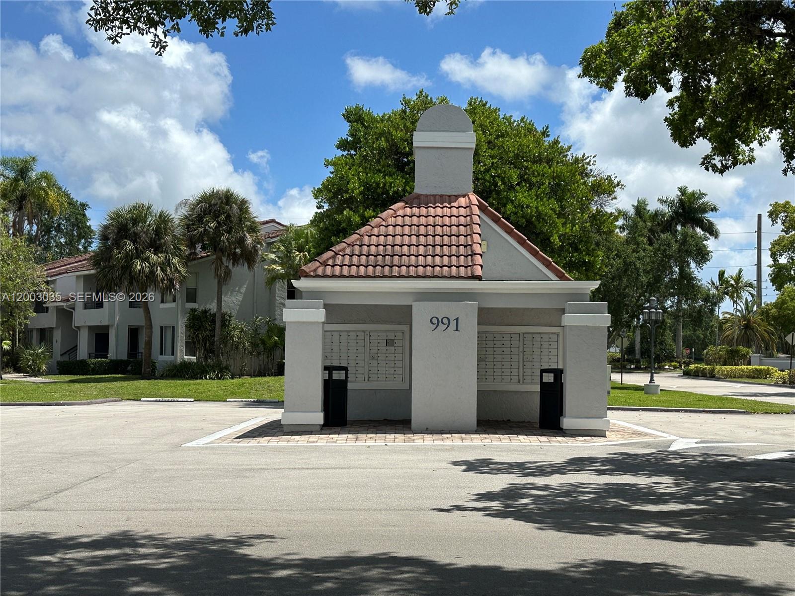 731 Lyons Road, Unit 16203 Coconut Creek, FL 33063 - Photo 14 of 14 a front view of a house with a yard