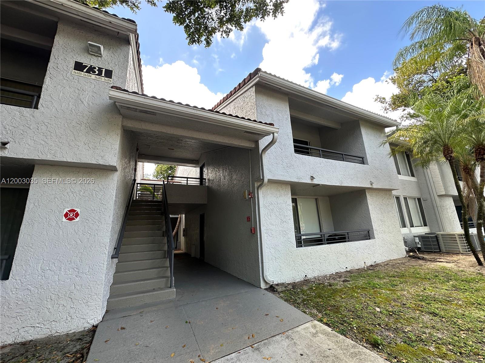 731 Lyons Road, Unit 16203 Coconut Creek, FL 33063 - Photo 2 of 14 a view of a garage of the house
