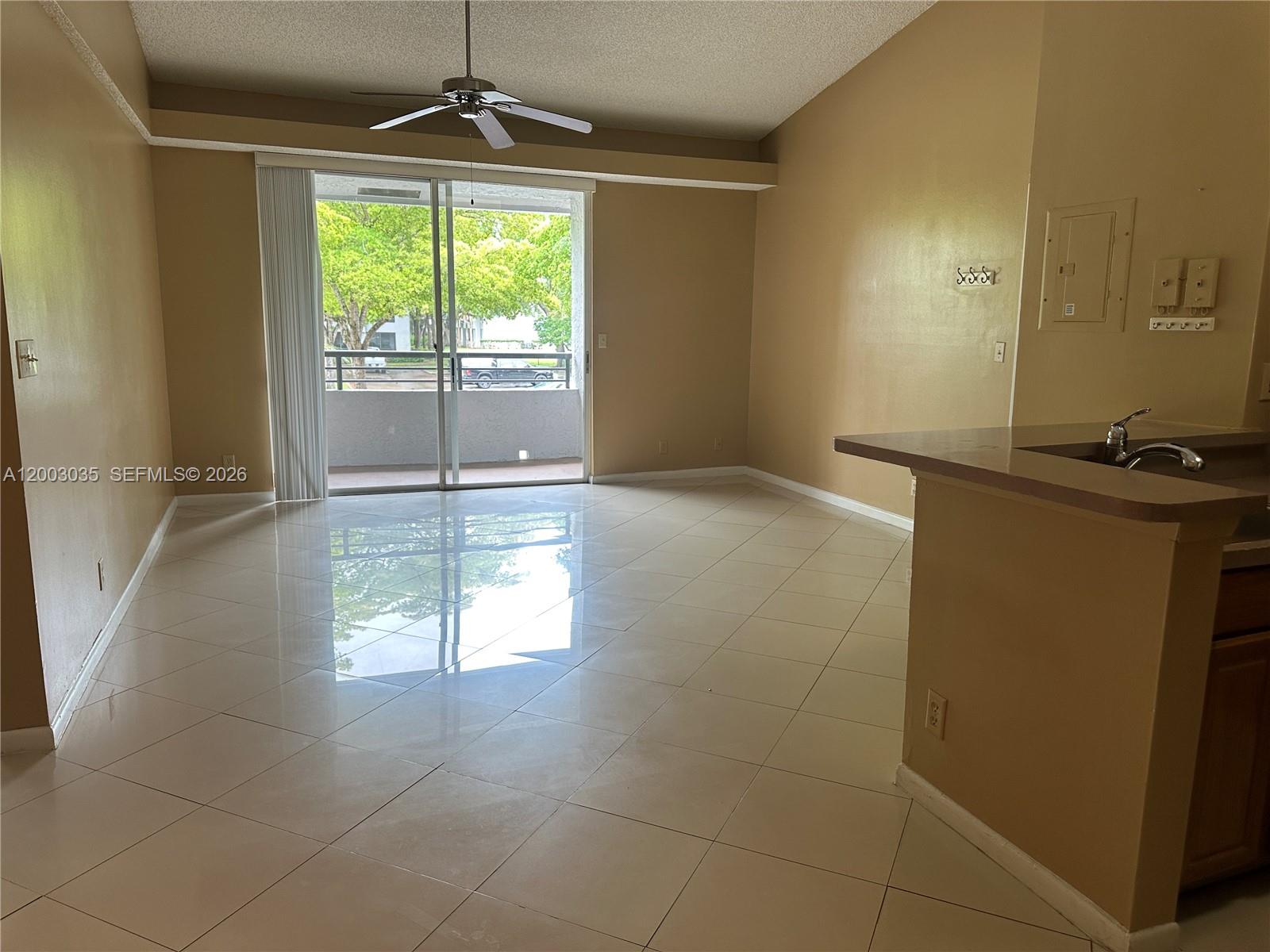 731 Lyons Road, Unit 16203 Coconut Creek, FL 33063 - Photo 4 of 14 a view of an empty room with a window