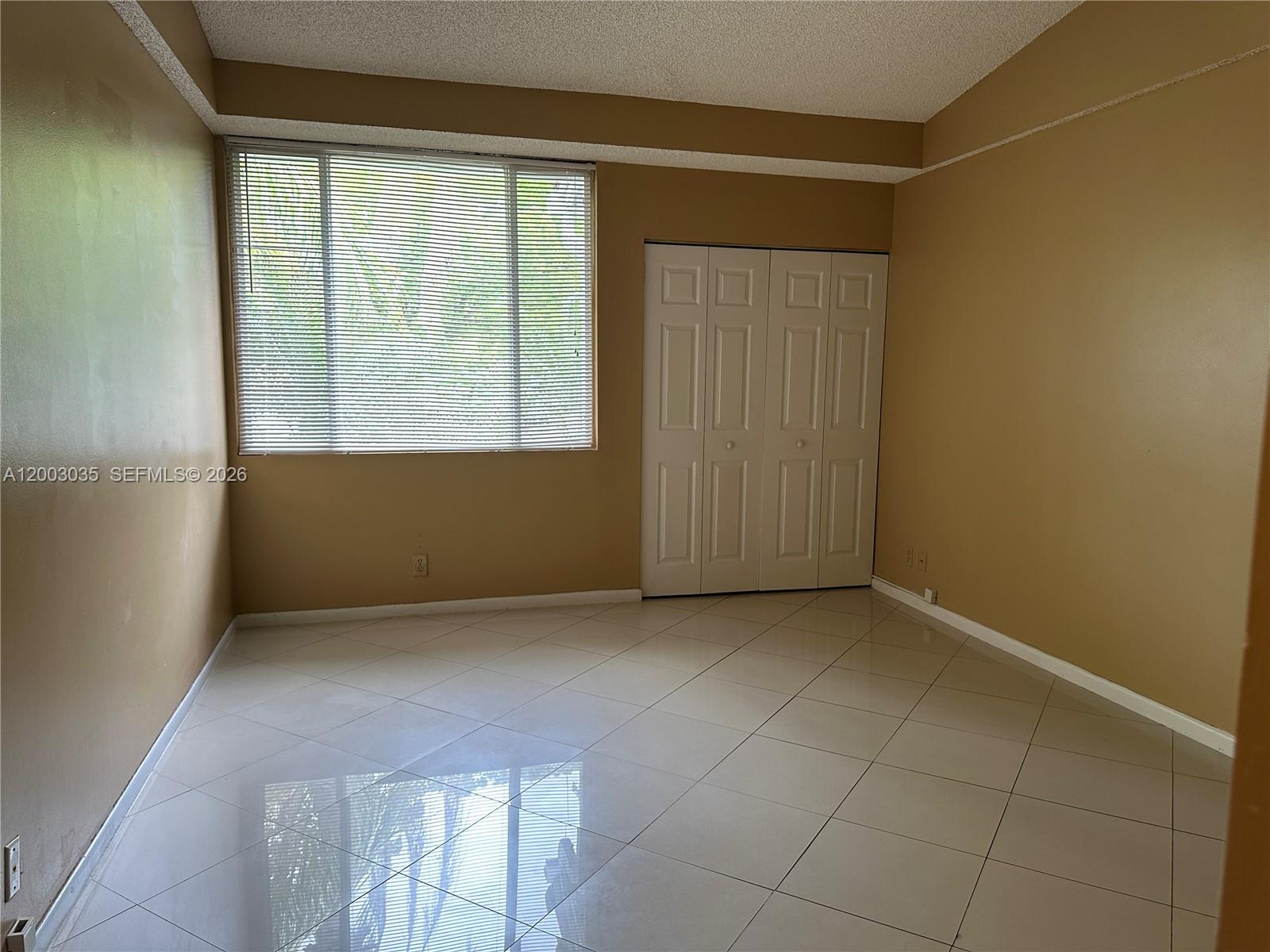 731 Lyons Road, Unit 16203 Coconut Creek, FL 33063 - Photo 7 of 14 an empty room with windows