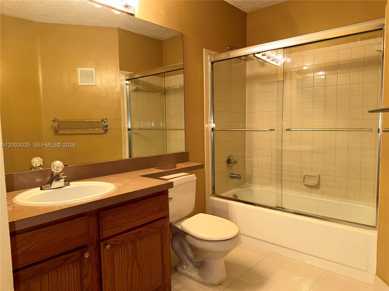 731 Lyons Road, Unit 16203 Coconut Creek, FL 33063 - Photo 8 of 14 a bathroom with a sink a toilet and shower