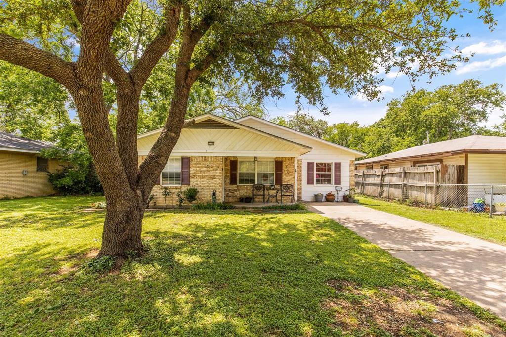 a front view of house with yard and trees