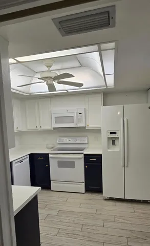 a kitchen with a cabinets and wooden floor