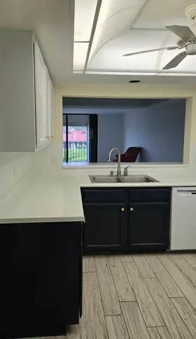 a kitchen with a sink a stove and cabinets