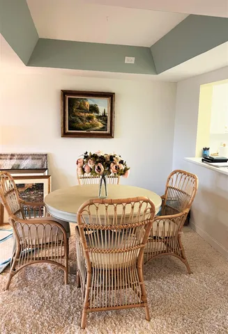 a living room with furniture and floor to ceiling windows