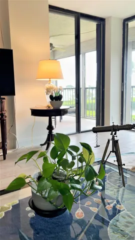 a view of a balcony with lake view and wooden floor