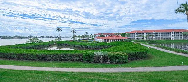 a view of a garden with a building in the background