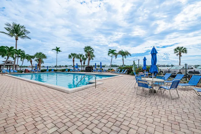 a view of a swimming pool with outdoor seating